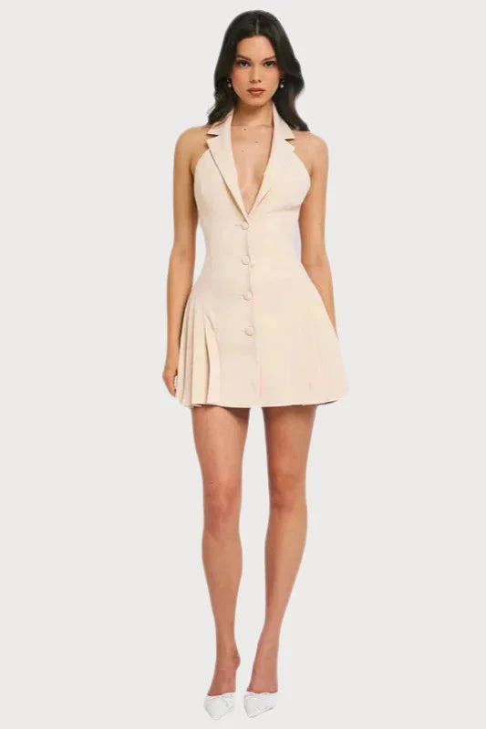 Short cream-colored halter dress with a plunging neckline and button front