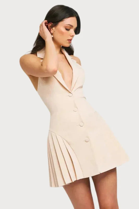 Sleeveless cream-colored mini dress with buttons and a pleated skirt detail